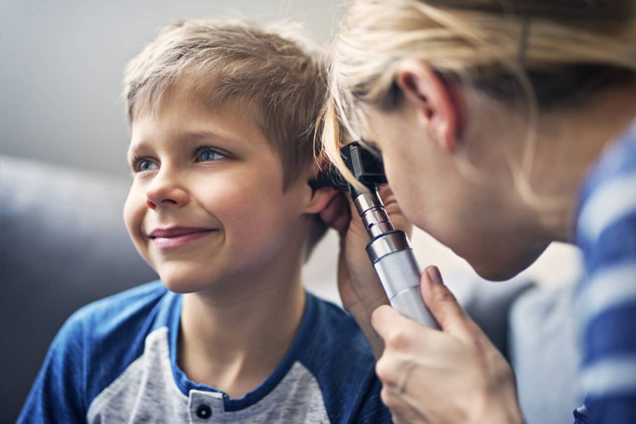 Little boy getting an ear exam from his doctor.