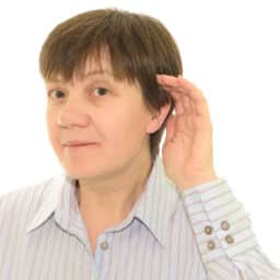 Woman with her hand to her ear straining to understand